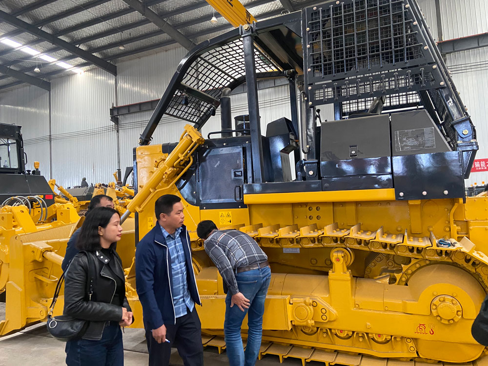 Des clients vietnamiens visitent la ligne de production de bulldozers chinois et passent commande de bulldozers SD22F version forestière 235HP